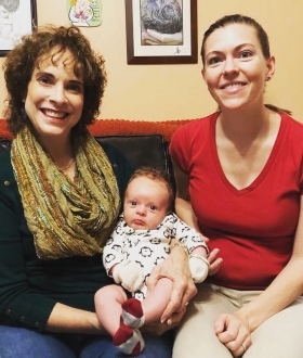 Midwife Cathy Rude, CPM, LM with happy client and baby at their six week postpartum visit at Katy Birth Center.