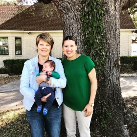Midwife Connie Blokkum, CNM and client with baby at their six week postpartum visit.